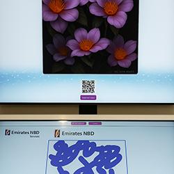 Guest using interactive screen for real-time AI painting at Dubai event, creating digital artwork with immersive technology experience by Mirror Booth Dubai